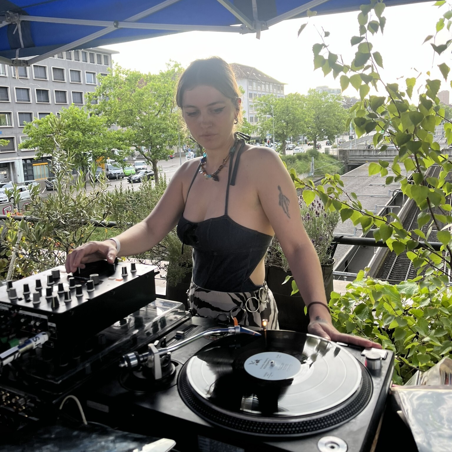 dj on rooftop playing vinyl